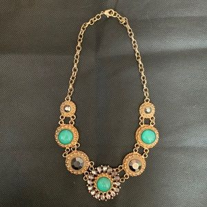Collar length necklace with turquoise and hematite stones. Antique gold finish